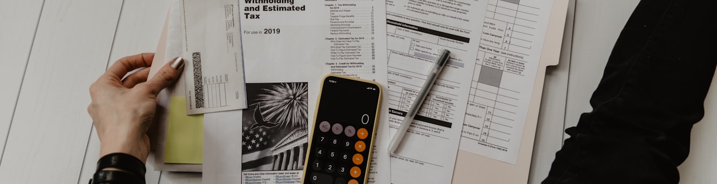 Receipts and a calculator, suggesting practical material stressors